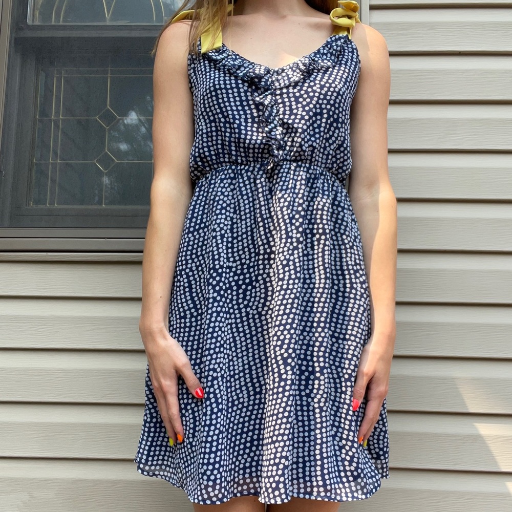 navy and white polka dot dress with yellow ribbon